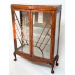 ART DECO DISPLAY CASE, figured walnut with two arched glazed doors enclosing shelves, 120cm H x 93cm