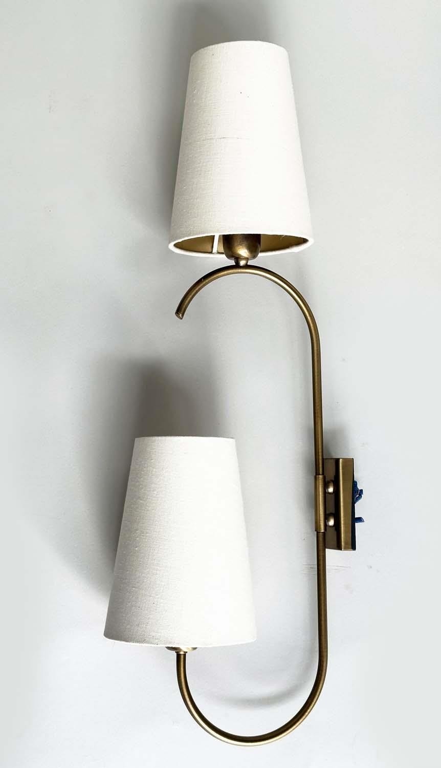 HEATHFIELD & CO WALL SCONCES, a set of four, bent gilt metal each with two branches and conical - Image 2 of 4