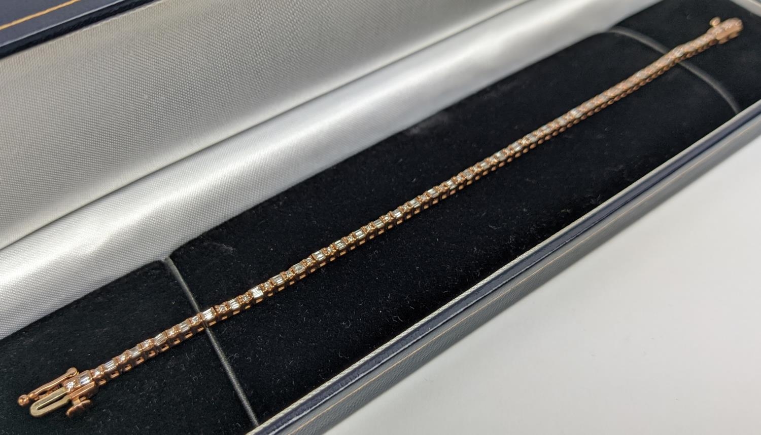 A 10CT ROSE GOLD AND DIAMOND SET BRACELET, set with alternating baguette and round brilliant cut - Image 2 of 9