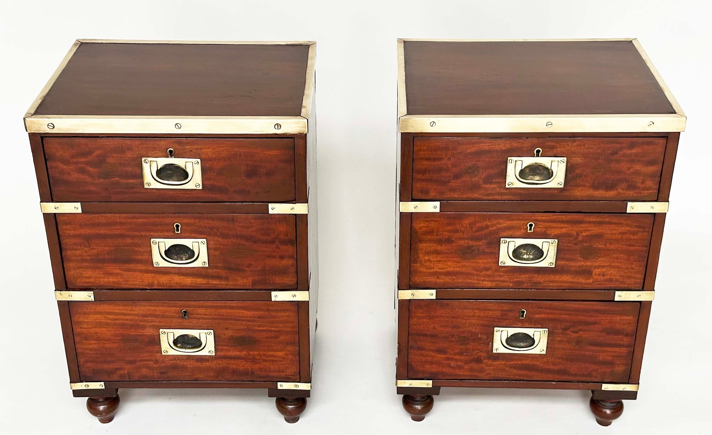 CAMPAIGN CHESTS, a pair, mahogany and brass bound each with three drawers and turned supports,