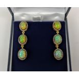 A PAIR OF SILVER-GILT OPAL AND DIAMOND SET PENDANT EARRINGS, of triple sectioned droplet form,