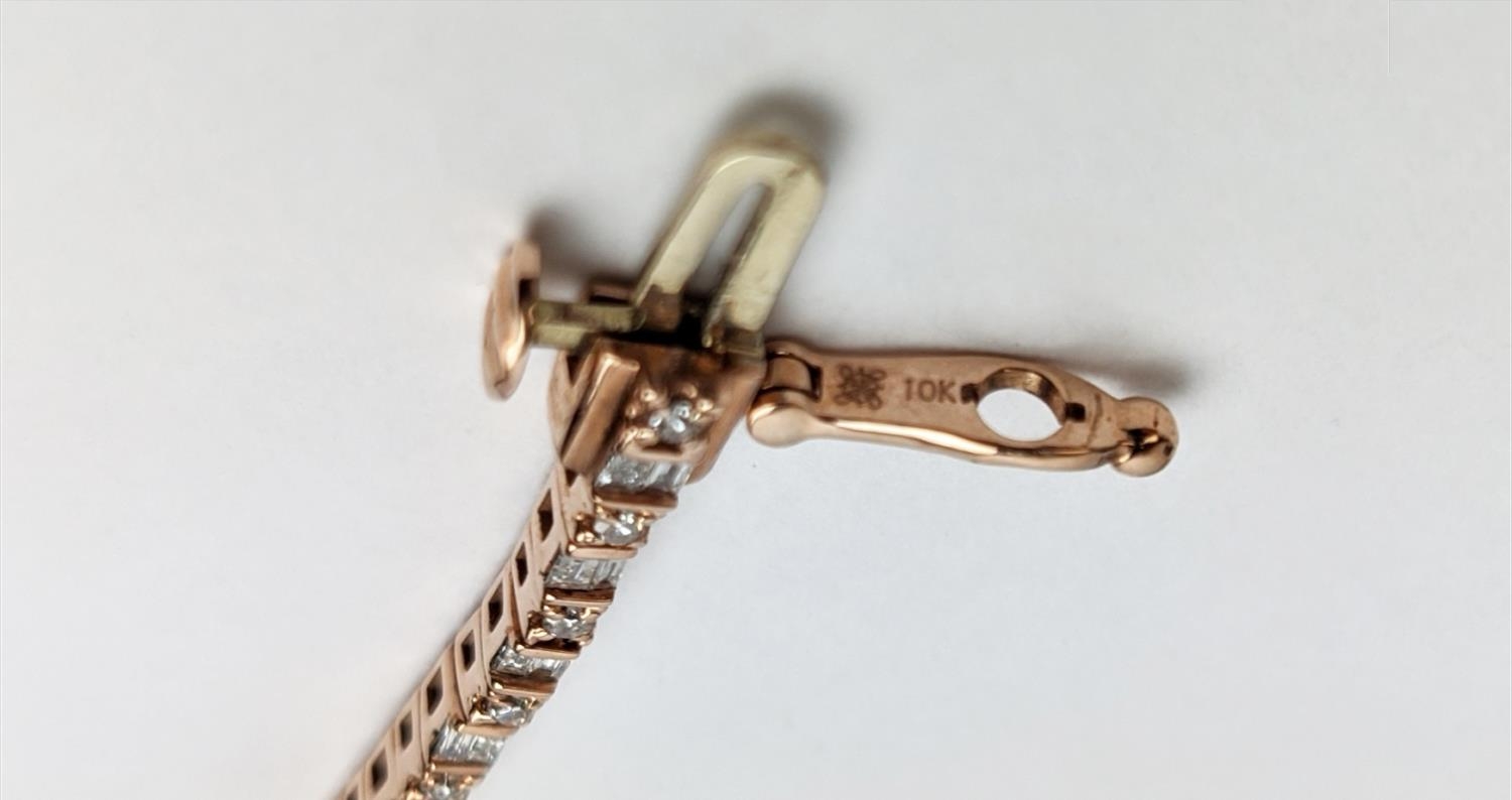 A 10CT ROSE GOLD AND DIAMOND SET BRACELET, set with alternating baguette and round brilliant cut - Image 9 of 9