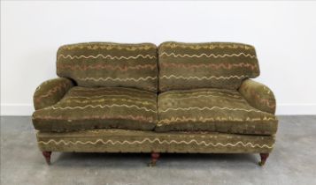 HOWARD STYLE SOFA, two seater with geometric upholstery and turned front supports with brass