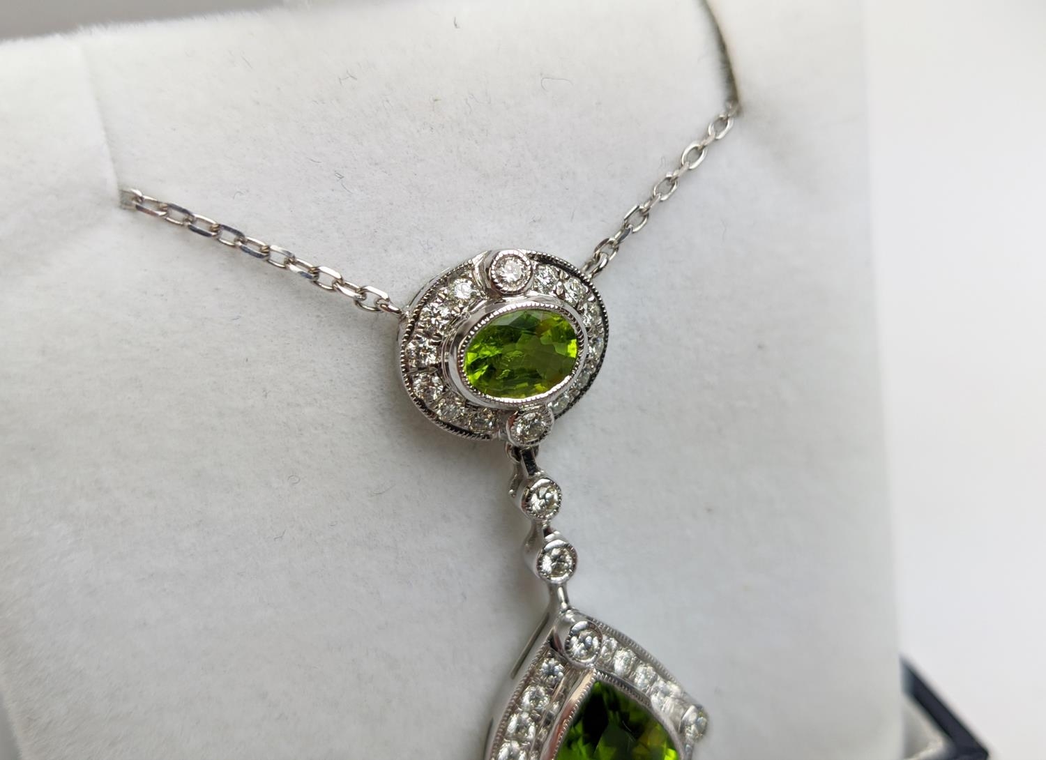 AN 18CT WHITE GOLD PERIDOT AND DIAMOND SET PENDANT NECKLACE, the pear shaped drop pendant surrounded - Image 4 of 10