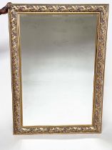 WALL MIRROR, rectangular gilt composition with pierced foliate frame, 176cm H x 114cm.