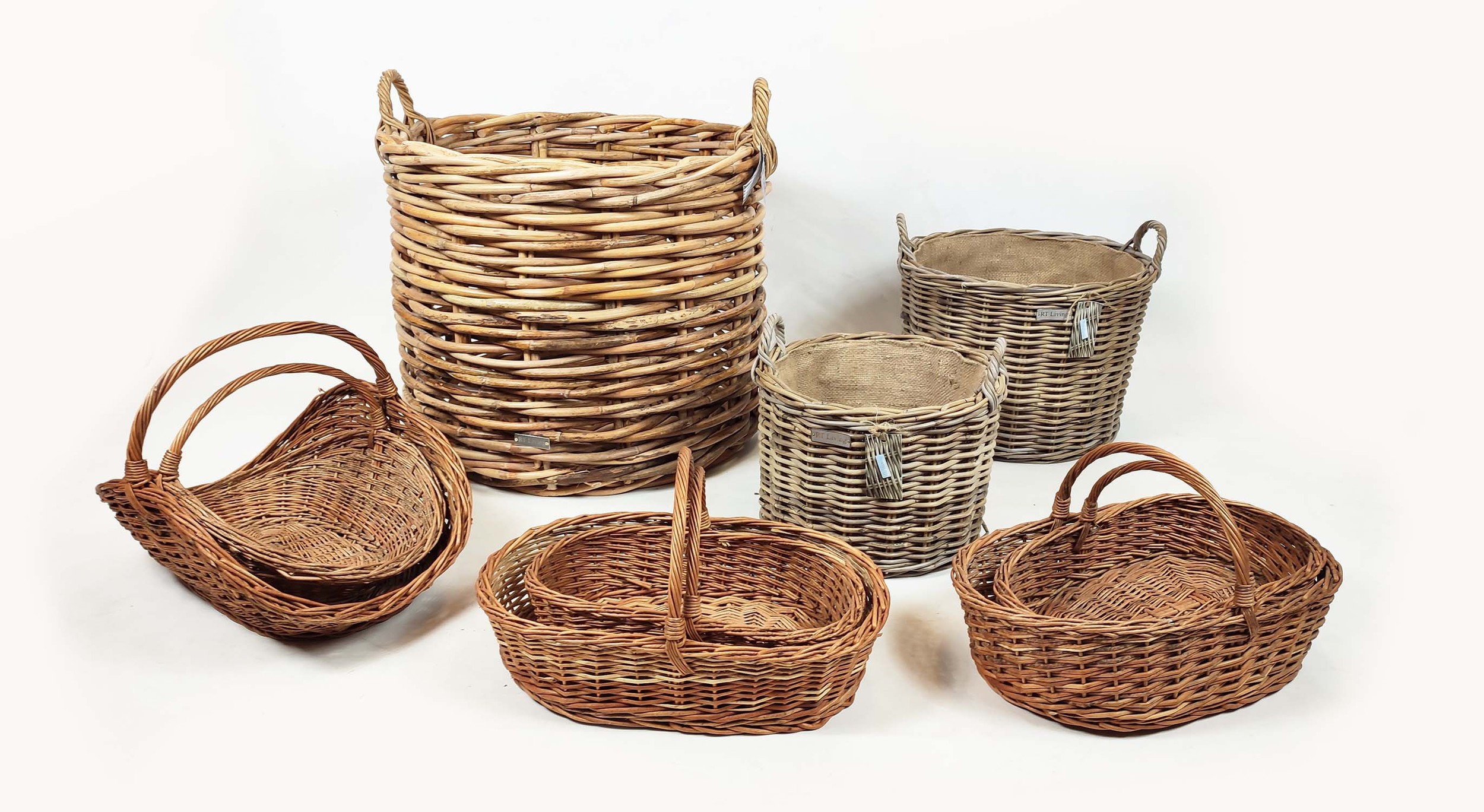 WICKER BASKETS, a collection of nine various, to include a large log basket and trugs, largest