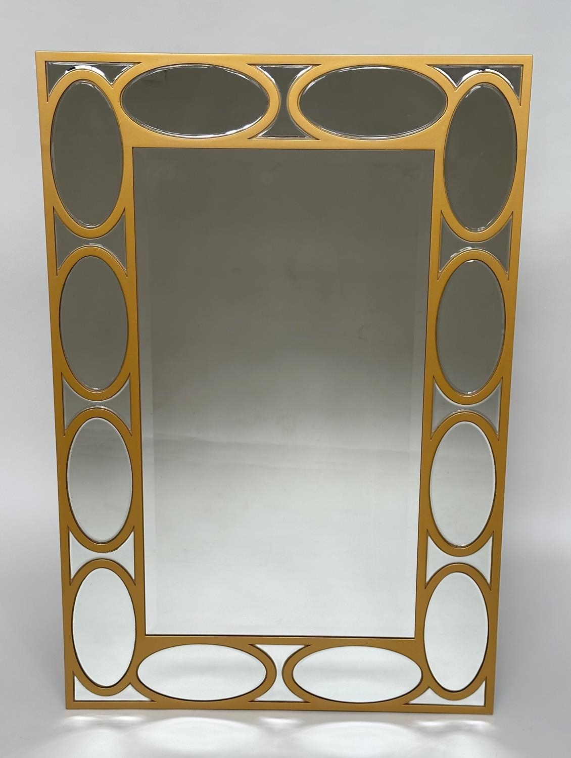 WALL MIRROR, rectangular gilt with oval panelled marginal plates and bevelled mirror throughout,