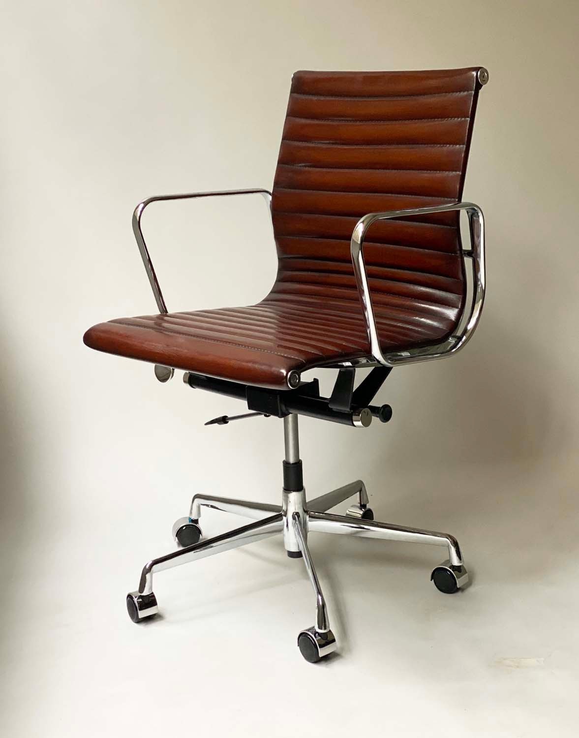 AFTER CHARLES AND RAY EAMES ALUMINIUM GROUP STYLE DESK, with ribbed natural mid brown leather