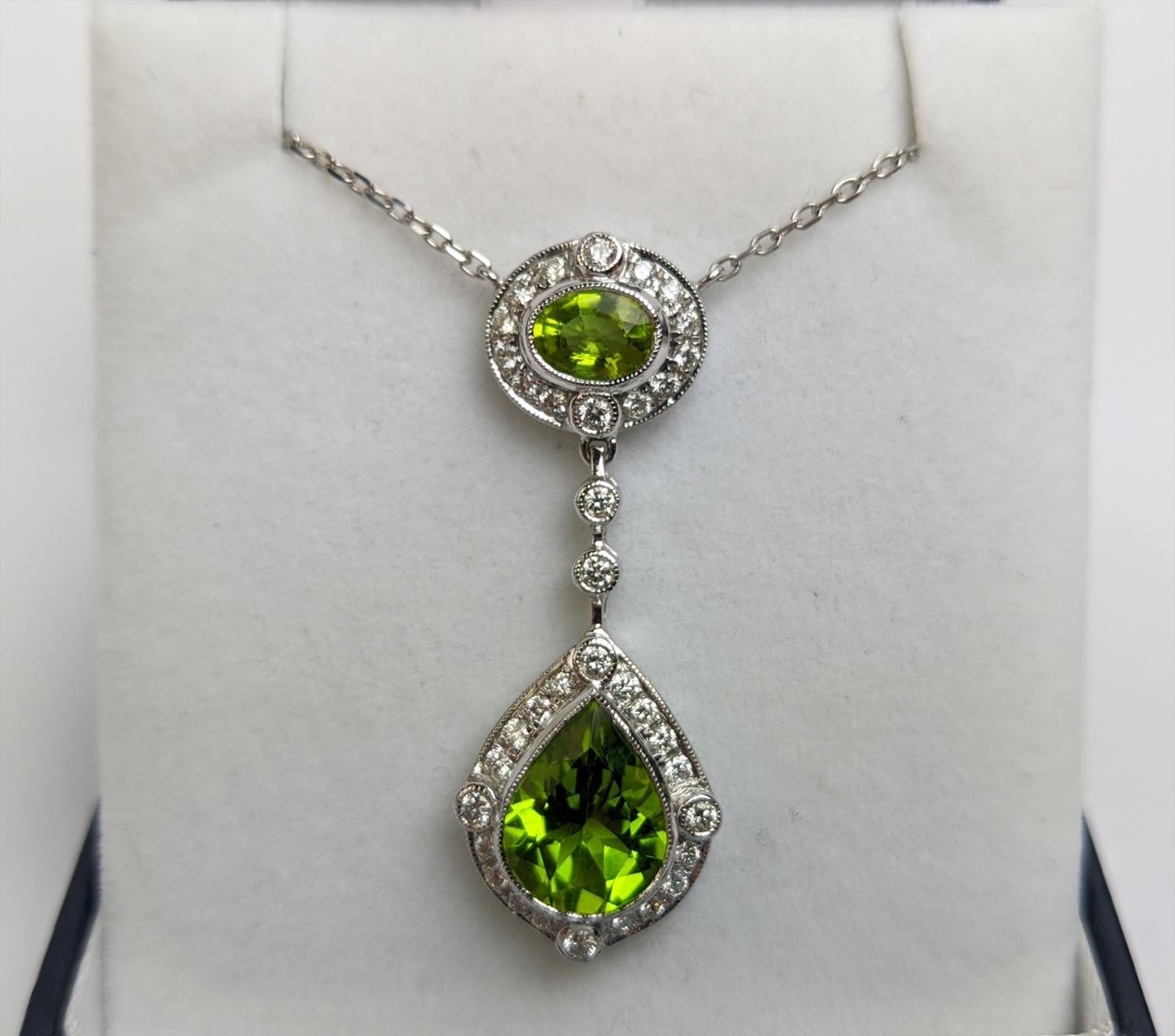 AN 18CT WHITE GOLD PERIDOT AND DIAMOND SET PENDANT NECKLACE, the pear shaped drop pendant surrounded - Image 2 of 10