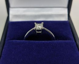 A PLATINUM DIAMOND SOLITAIRE RING, the single princess cut stone of approximately 0.33 carats,