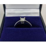 A PLATINUM DIAMOND SOLITAIRE RING, the single princess cut stone of approximately 0.33 carats,