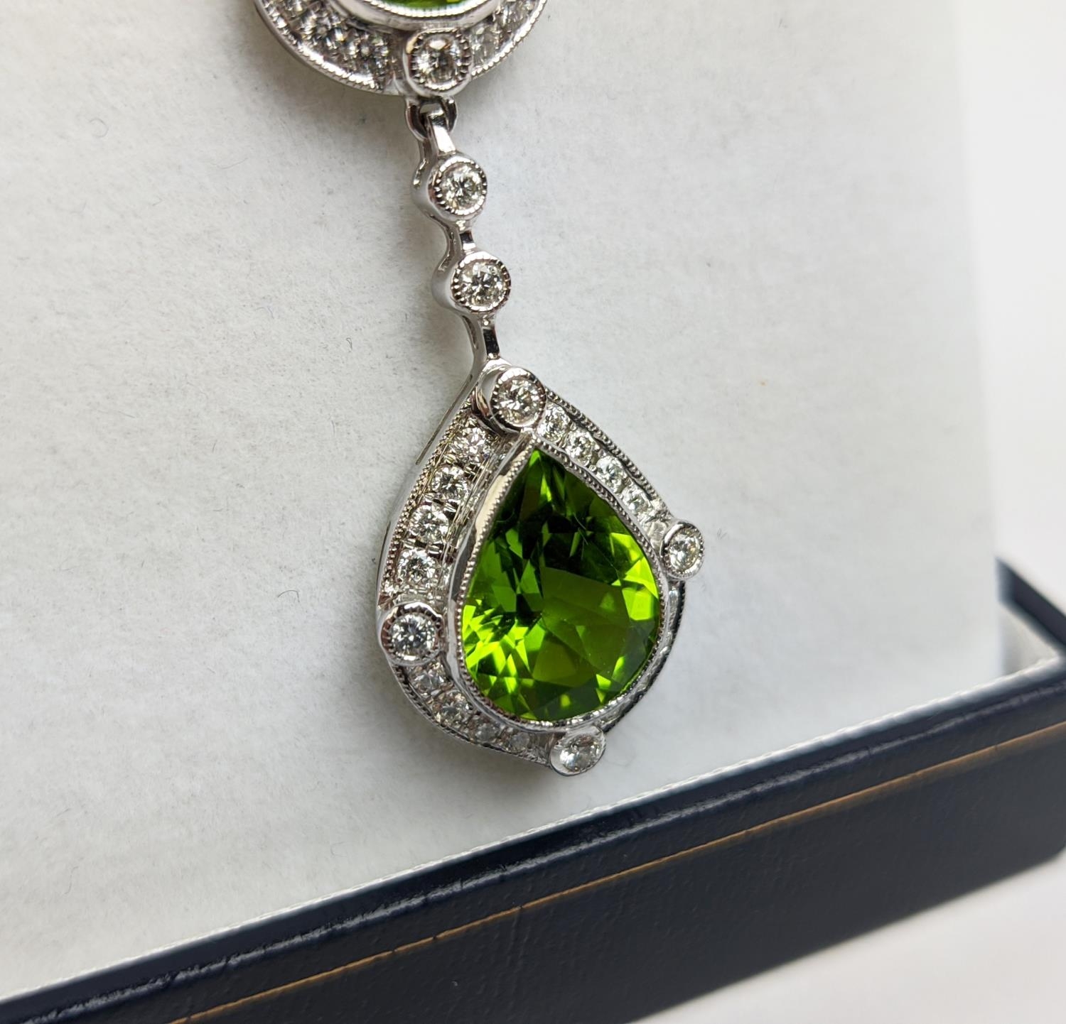 AN 18CT WHITE GOLD PERIDOT AND DIAMOND SET PENDANT NECKLACE, the pear shaped drop pendant surrounded - Image 5 of 10