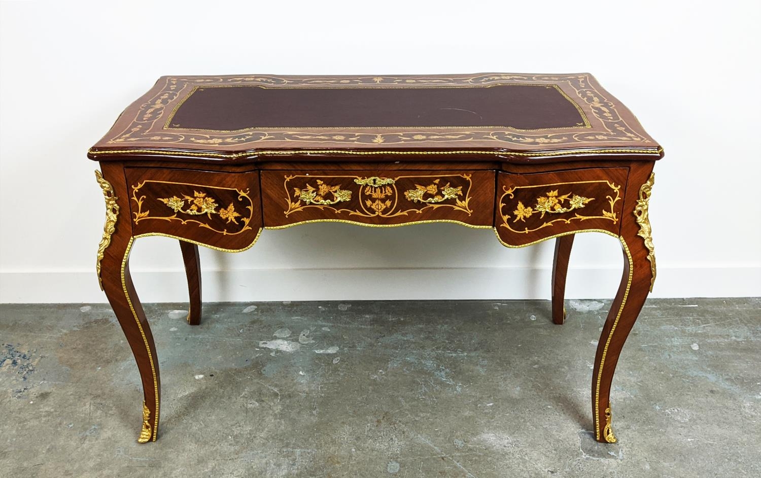 BUREAU PLAT, French style marquetry with three drawers and gilt mounts, 120cm x 79cm H x 62cm.