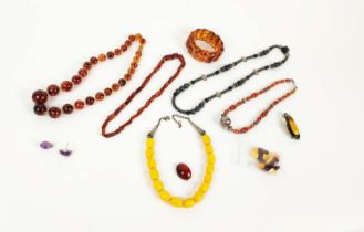 A COLLECTION OF ASSORTED JEWELLERY, including amber necklaces, amber set Art Nouveau brooch,