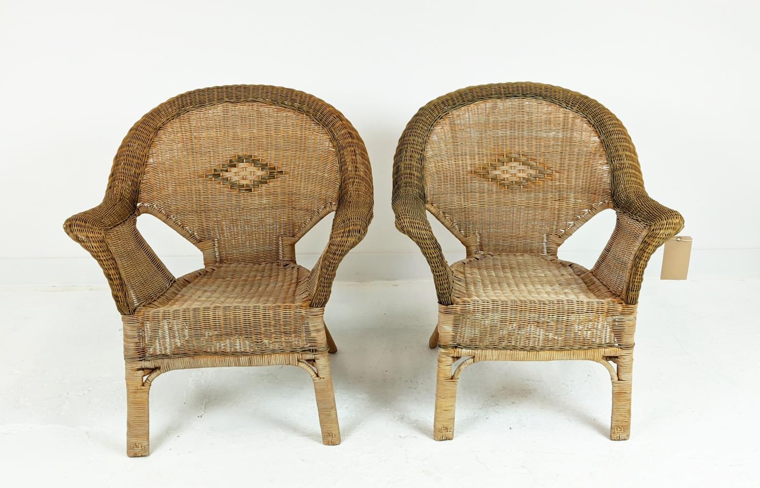 CONSERVATORY ARMCHAIRS, a pair, mid 20th century rattan framed and two tone cane with arched