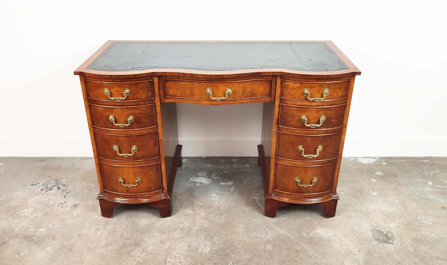 KNEEHOLE DESK, Georgian style, burr walnut with black leather top above nine bowed drawers, 75cm H x