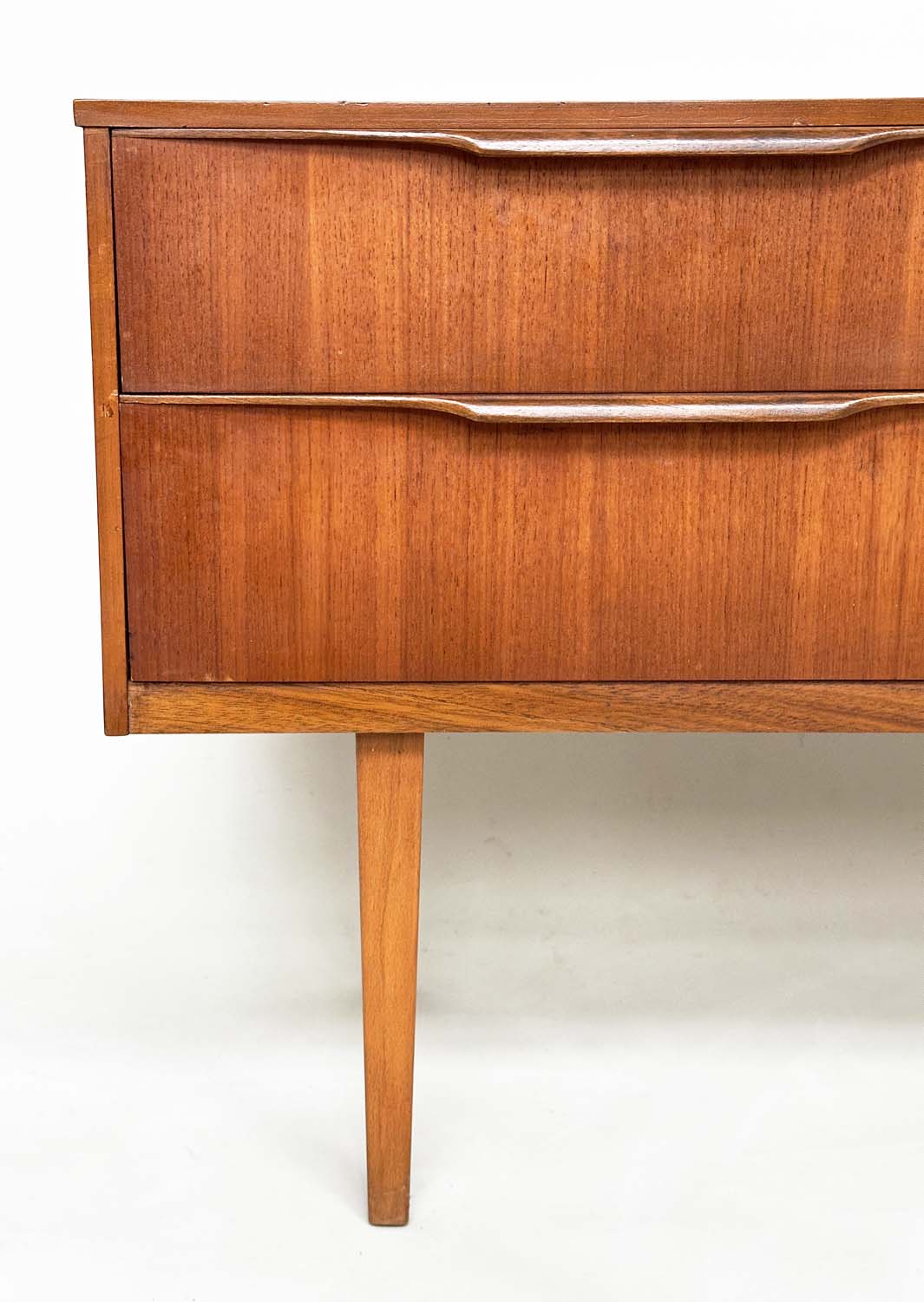 AUSTIN SUITE LOW CHEST, 1970s teak with four drawers, 128cm W x 70cm H x 41cm D. - Image 4 of 11
