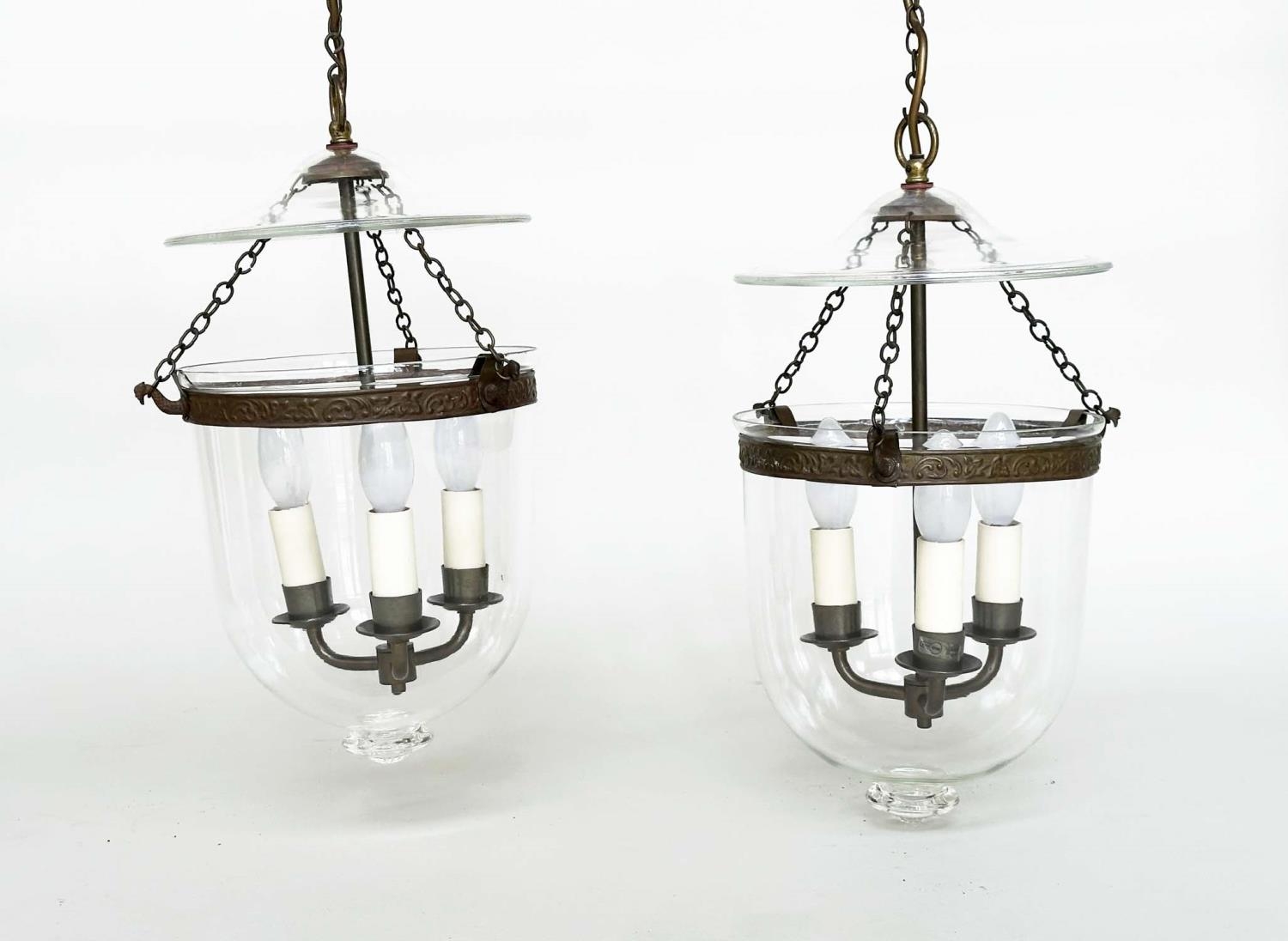 HALL LANTERNS, a pair, glass and bronzed metal each with three lights, 40cm H x 23cm. (2)