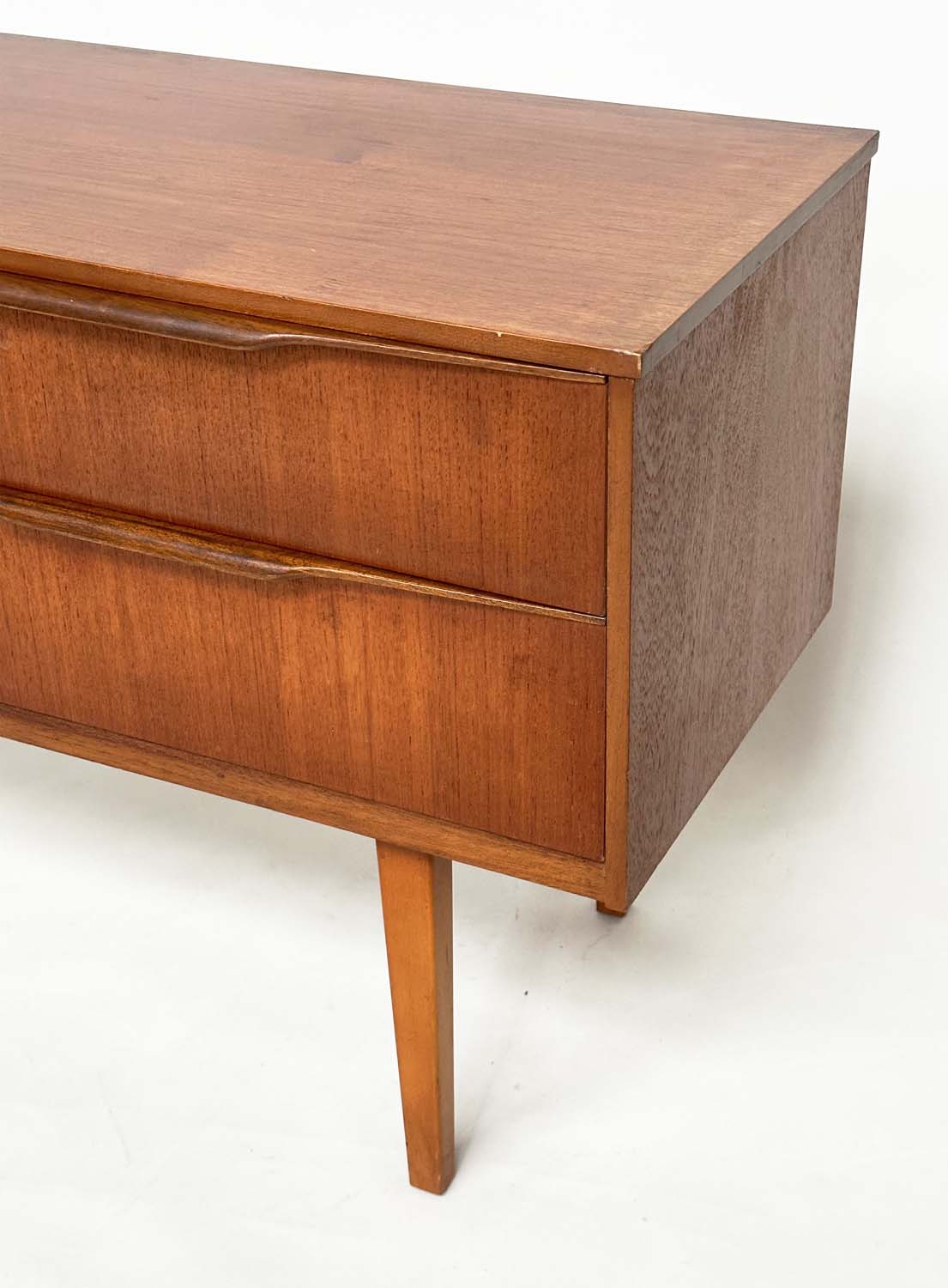 AUSTIN SUITE LOW CHEST, 1970s teak with four drawers, 128cm W x 70cm H x 41cm D. - Image 10 of 11