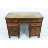 KNEEHOLE DESK, Regency mahogany, with faded tan leather top over seven drawers, 113cm W x 52cm D x