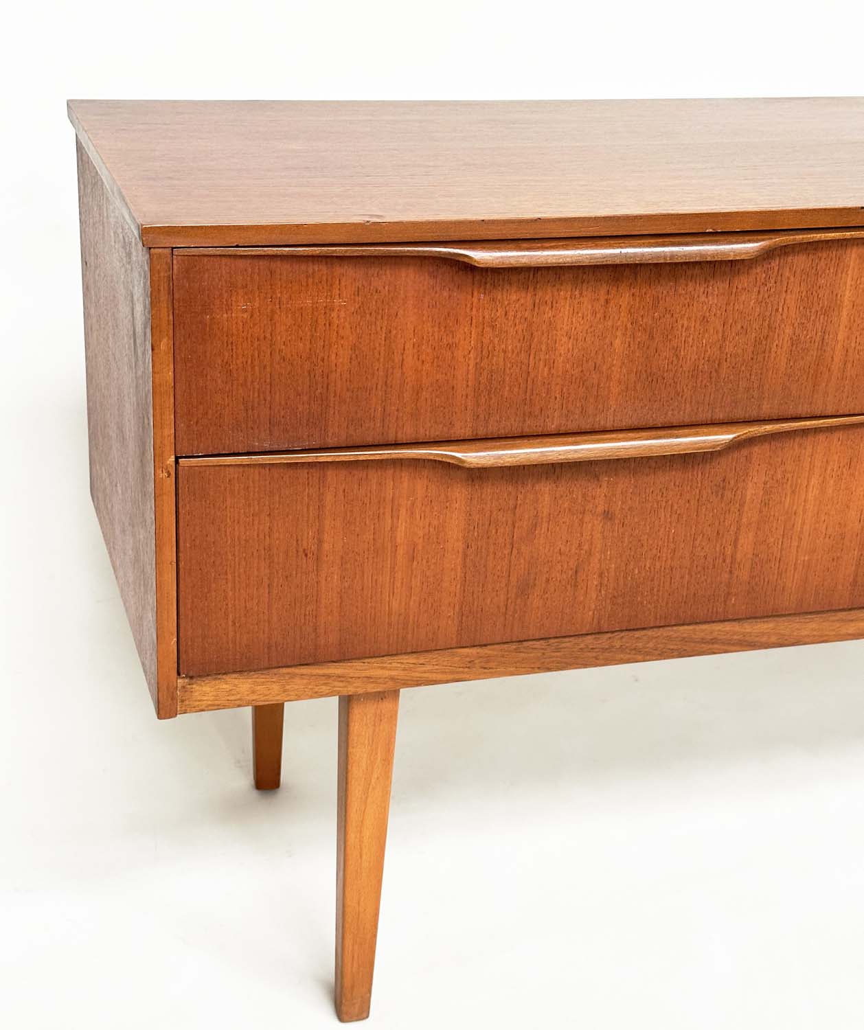 AUSTIN SUITE LOW CHEST, 1970s teak with four drawers, 128cm W x 70cm H x 41cm D. - Image 9 of 11