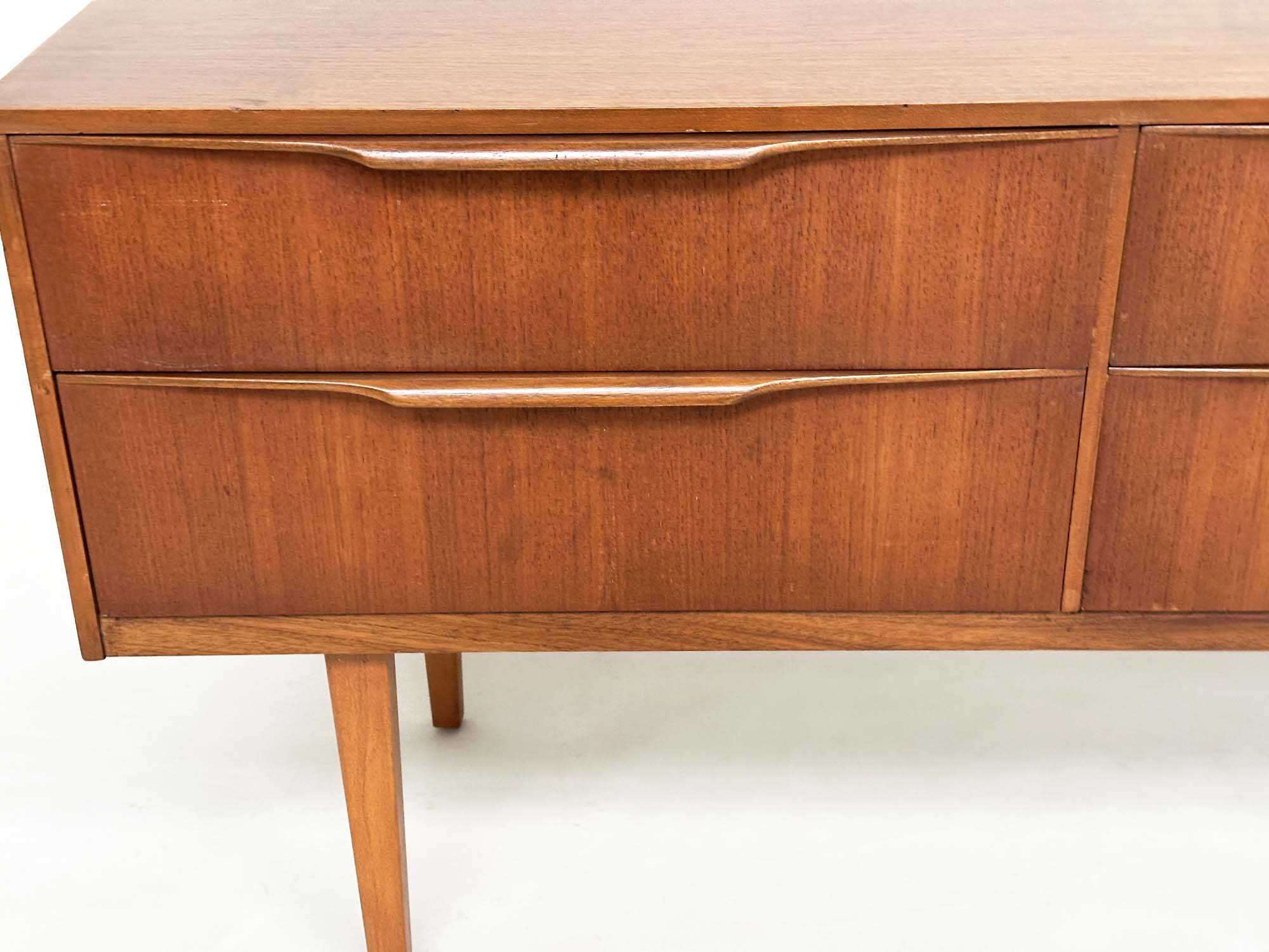 AUSTIN SUITE LOW CHEST, 1970s teak with four drawers, 128cm W x 70cm H x 41cm D. - Image 8 of 11