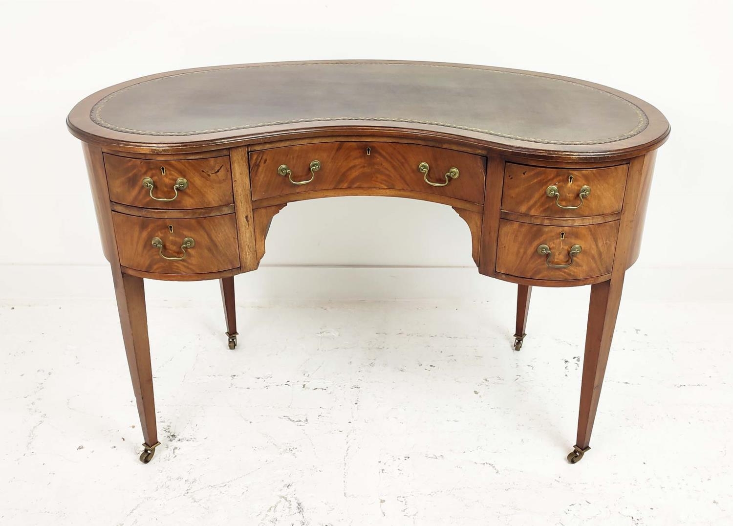 KIDNEY SHAPED DESK, Edwardian mahogany, with inlaid tooled brown leather top over five drawers,