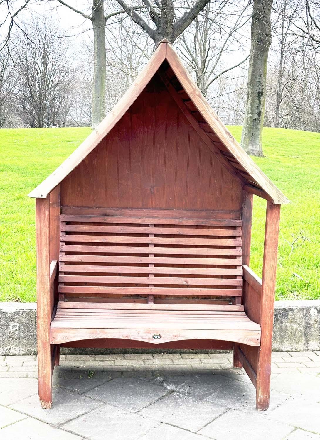 ARBOUR SEAT, traditional form well weathered treated softwood with slatted seat and boarded gable - Image 2 of 5