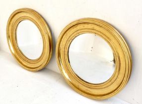 WALL MIRRORS, a pair, Regency style, gilt frames, 52cm across. (2)