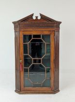 GLAZED CORNER CABINET, George III mahogany with carved blind fretwork detail with fluted detail