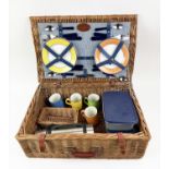 G.T.C. PICNIC BASKET, four place setting, including plates, cutlery, mugs, flask and tuperware in