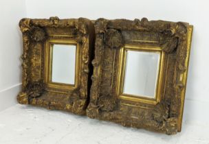 WALL MIRRORS, a pair, oversized Rococo gilt frames, 55cm x 50cm.