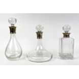 DECANTERS, three ships decanter for port, brandy and whiskey with silver collars, tallest 30cm H. (