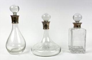 DECANTERS, three ships decanter for port, brandy and whiskey with silver collars, tallest 30cm H. (