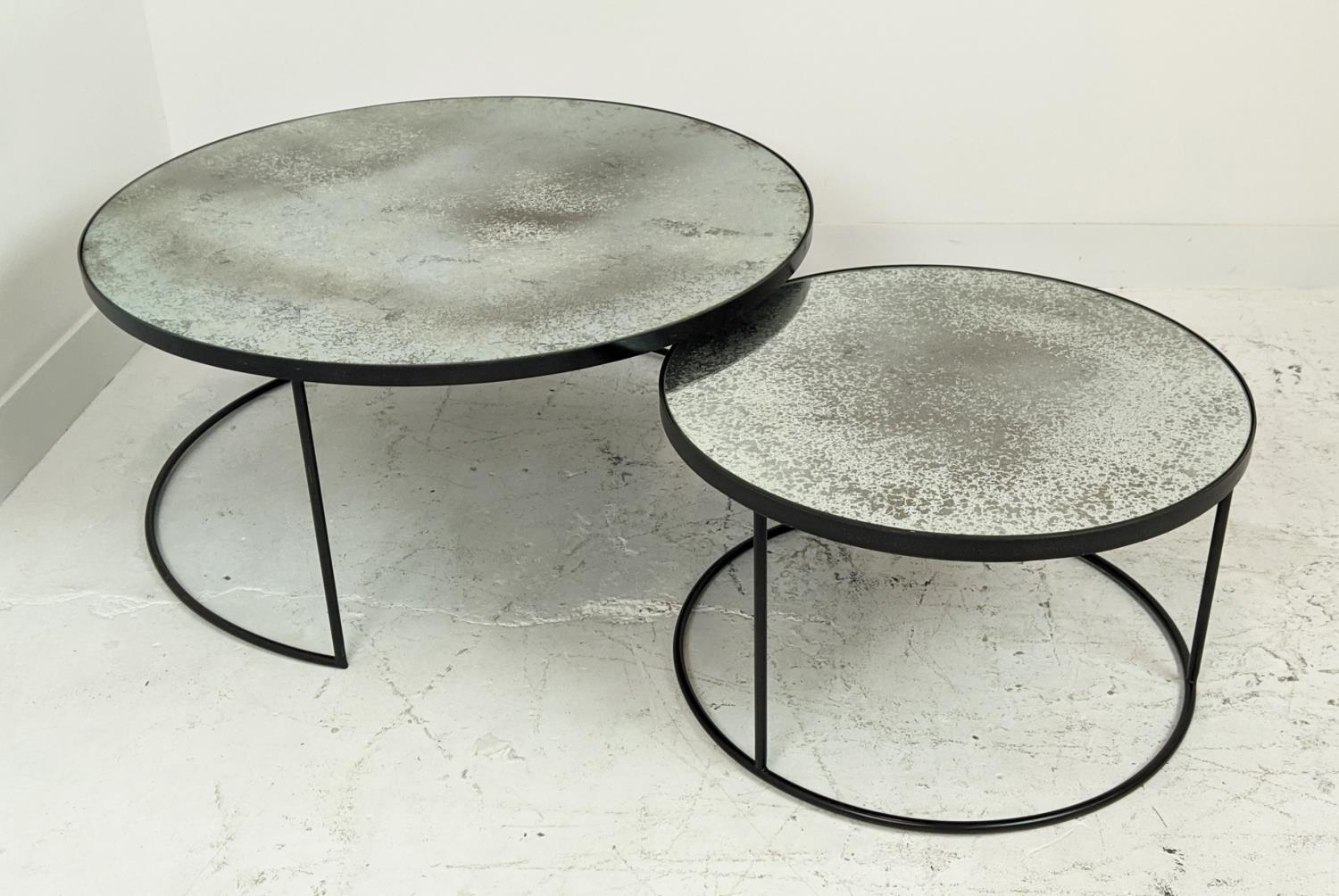 LOW TABLES, a nesting pair, with circular antiqued mirrored tops, largest 90cm W x 42cm H.