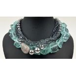 AN AQUAMARINE COLOURED ROUGH STONE NECKLACE, with a paste diamond clasp, 46cm long, together with