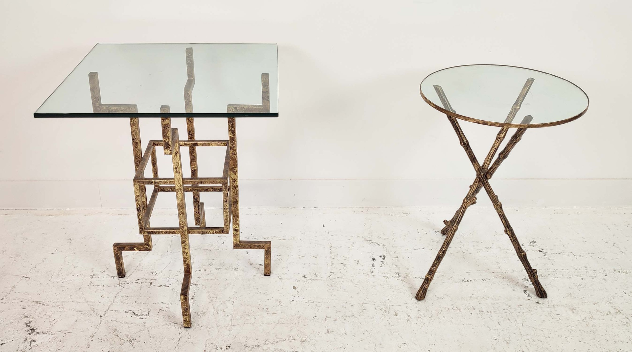 SIDE TABLES, two differing 1970s French inspired designs, gilt metal and glass. (2)