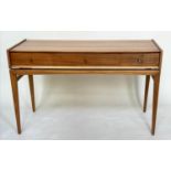 A YOUNGER WRITING TABLE, 1970s teak with three frieze drawers and tapering supports (stamped to