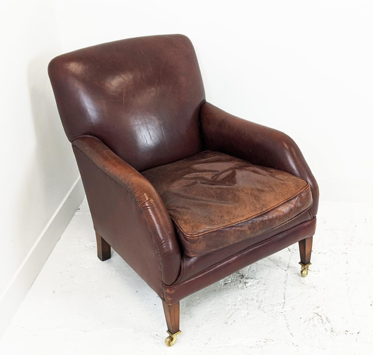 LIBRARY ARMCHAIR, studded tan leather raised on brass castors, 84cm H x 68cm W. - Image 2 of 9