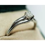 A DIAMOND SOLITAIRE RING, the Princess brilliant cut stone of 0.25 carat, white metal shank, ring