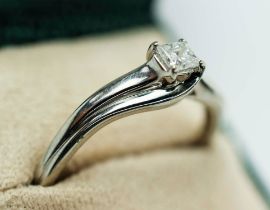 A DIAMOND SOLITAIRE RING, the Princess brilliant cut stone of 0.25 carat, white metal shank, ring