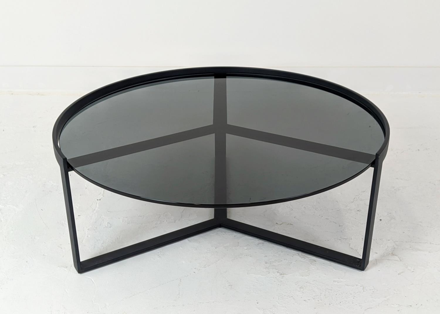 LOW TABLE, with a circular smoked glass top on a metal frame, 91cm W x 37cm H.