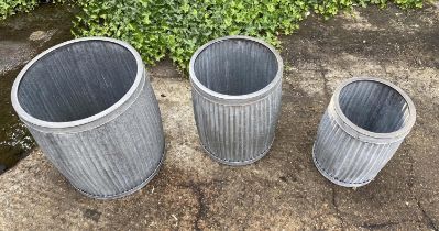 PLANTERS, a graduated set of three, in ribbed zinc, largest 50cm H x 45cm x 45cm. (3)