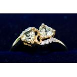 A 9CT GOLD QUARTZ AND DIAMOND SET DRESS RING, set with two heart shaped quartz stones and diamond