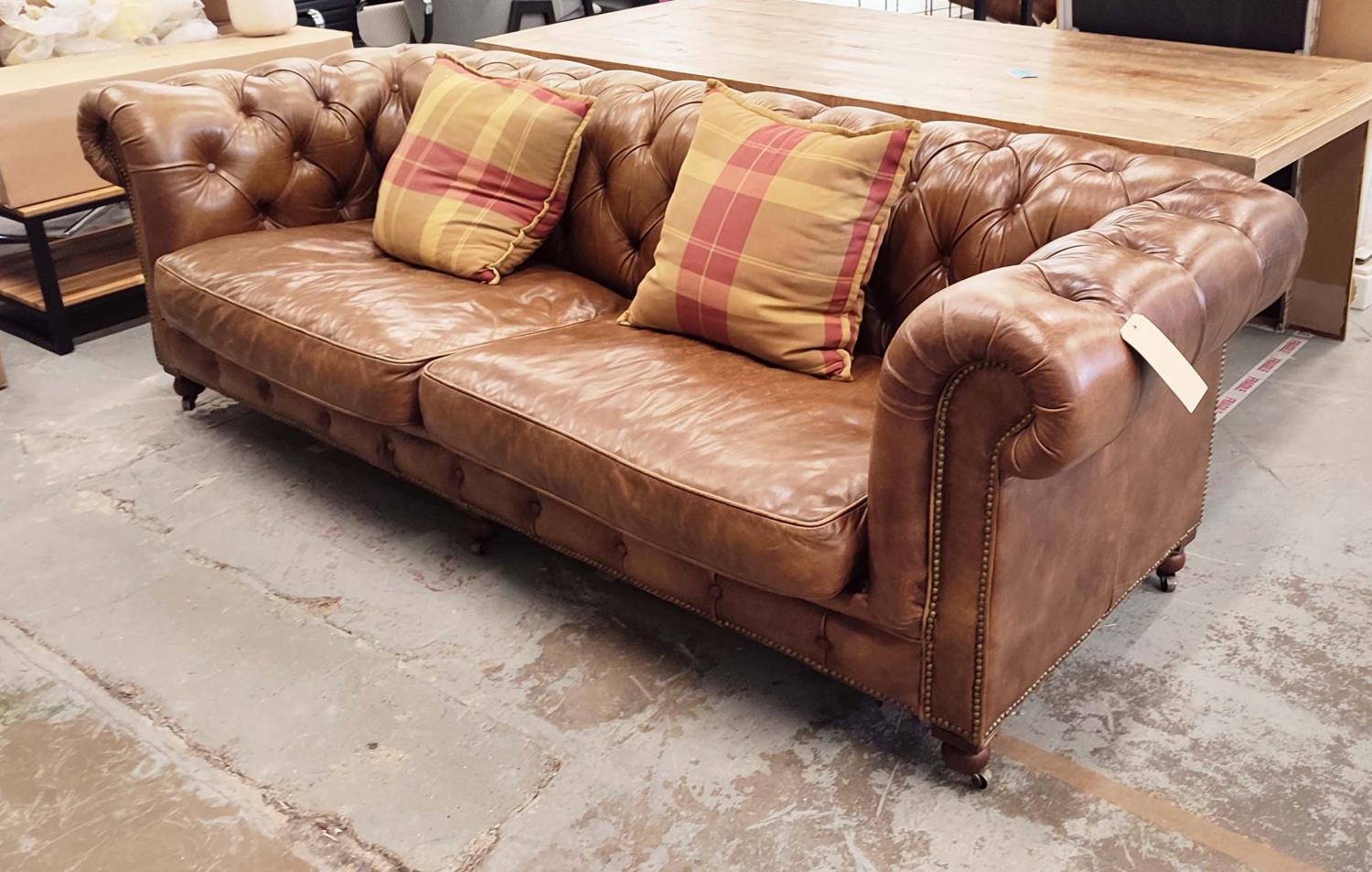 CHESTERFIELD SOFA, in buttoned brown leather, 95cm D x 80cm H x 255cm W, with two cushions.
