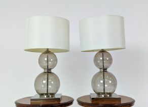TABLE LAMPS, a pair, glass ball stems on square polished metal bases, 61cm H x 35cm W in shades. (2)