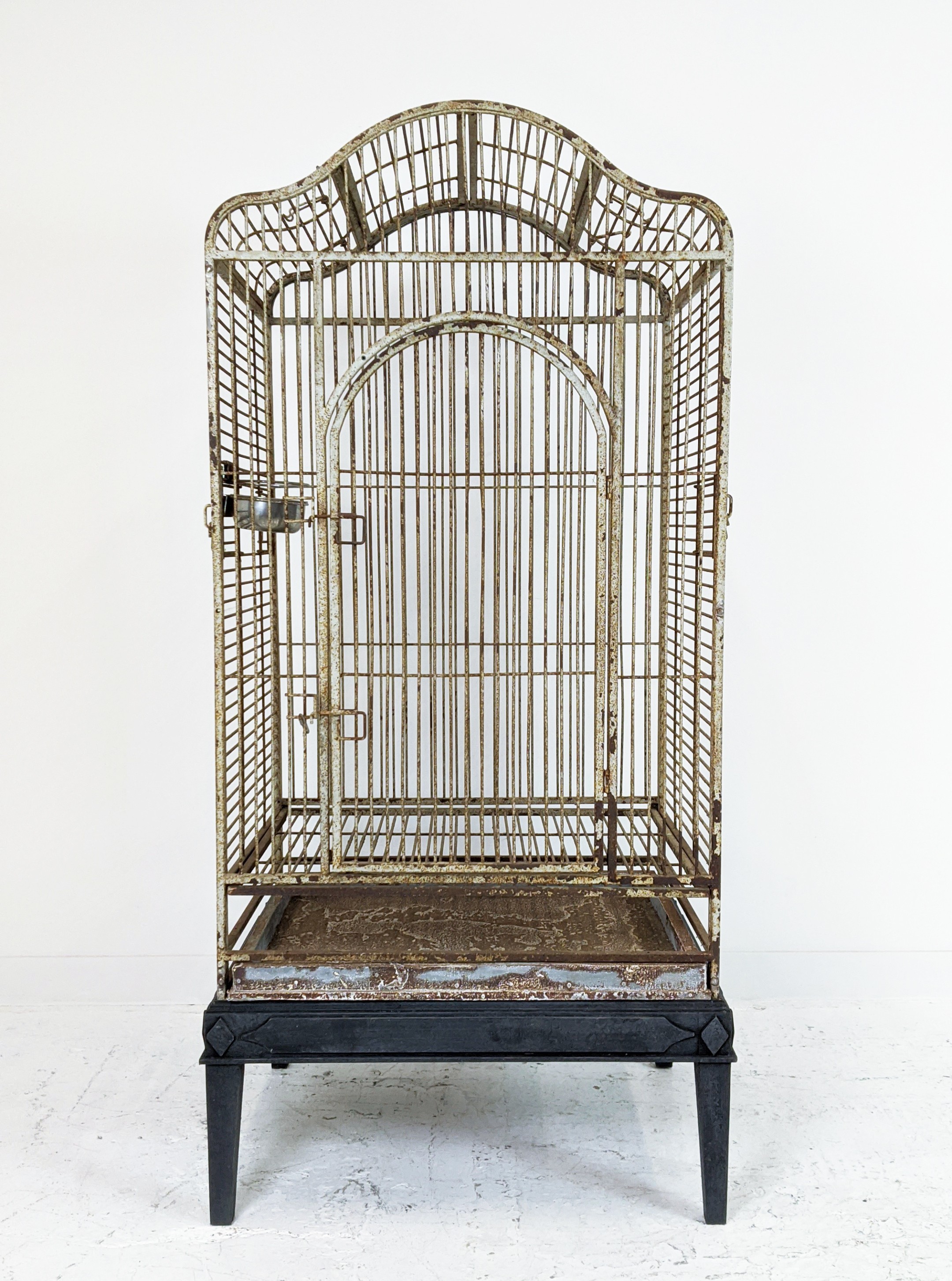 PARROT CAGE, painted iron on later ebonised stand, 178cm H x 86cm W x 66cm D.