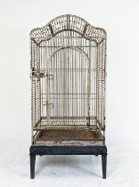 PARROT CAGE, painted iron on later ebonised stand, 178cm H x 86cm W x 66cm D.