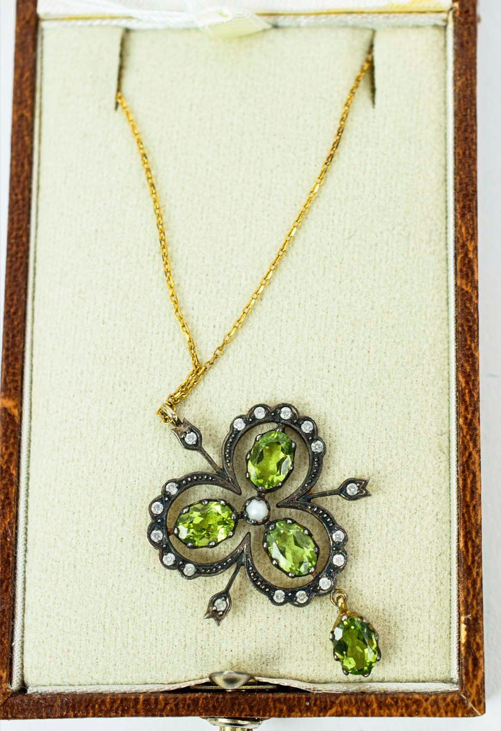 A VICTORIAN-STYLE PENDANT NECKLACE, of trefoil form, set with peridots, diamonds and a central