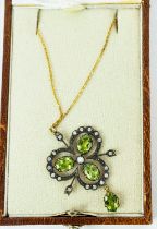 A VICTORIAN-STYLE PENDANT NECKLACE, of trefoil form, set with peridots, diamonds and a central